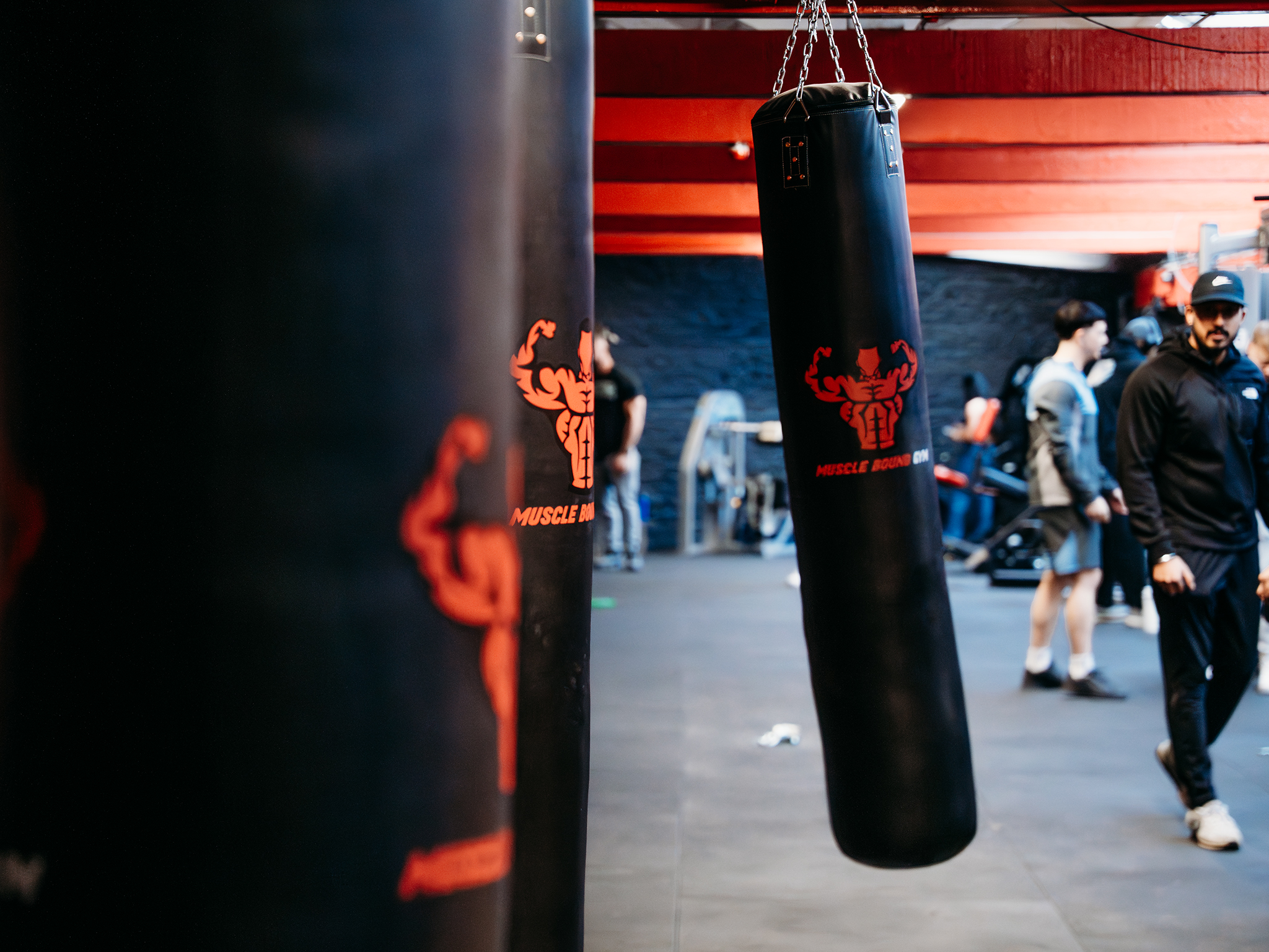 Muscleboundg gym red and black boxing area with punch bag